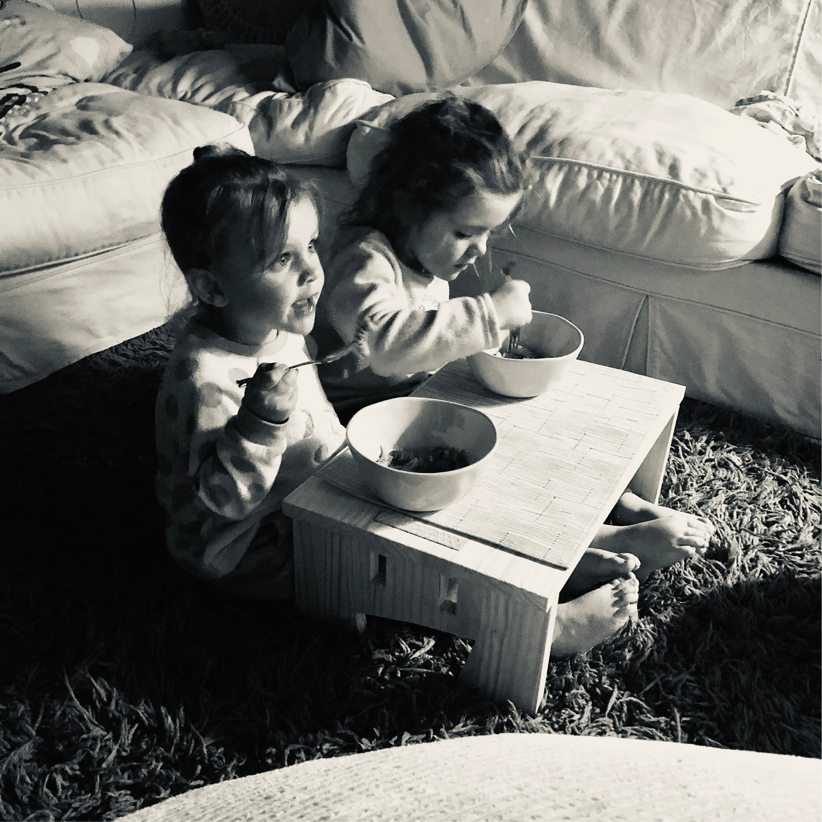 two kids using the MyDinky step as a table to eat dinner