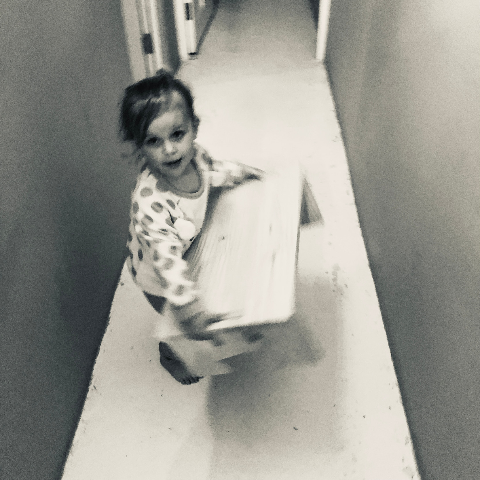 Black and white photo of a child carrying the mydinky step