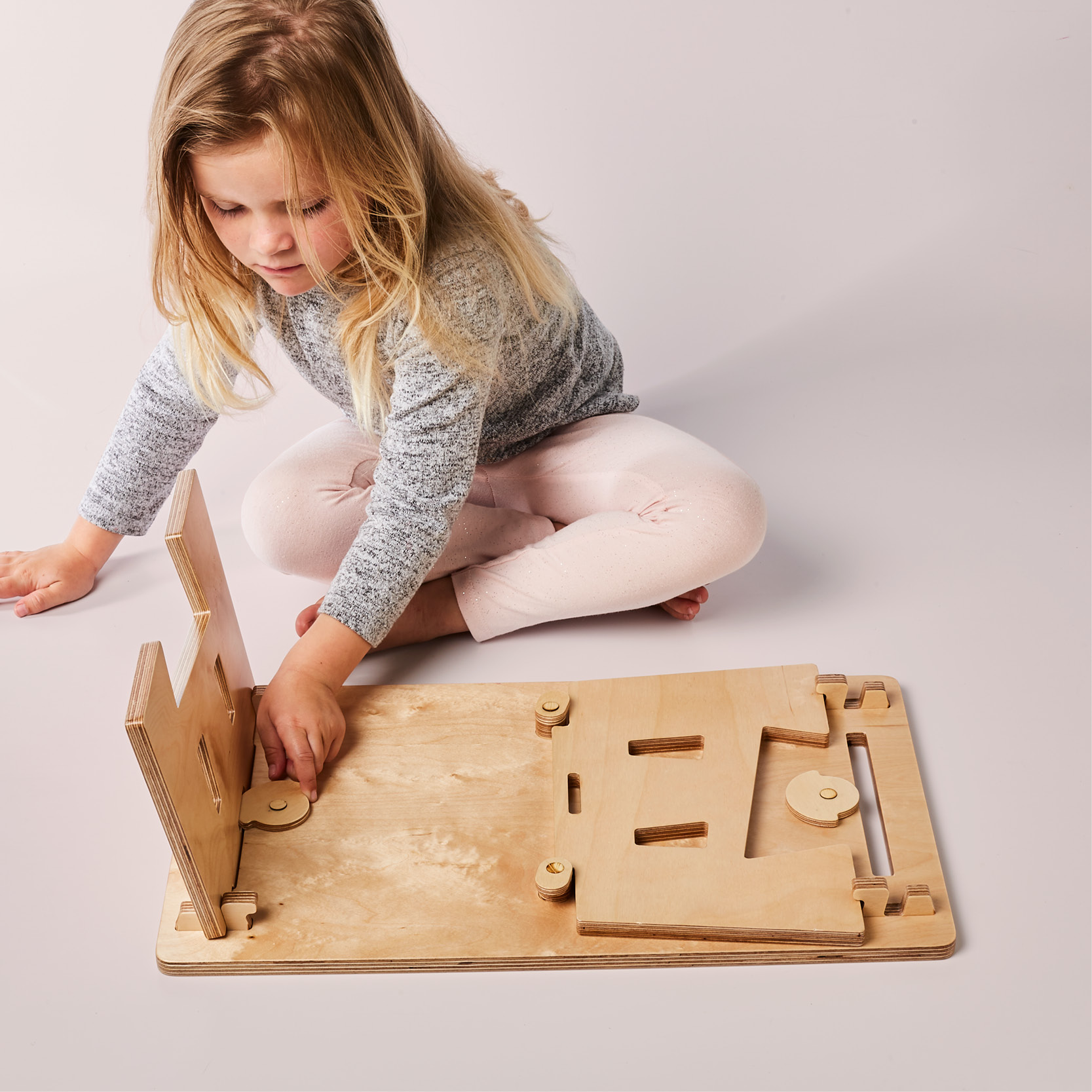 child assembling the mydinky step sitting down