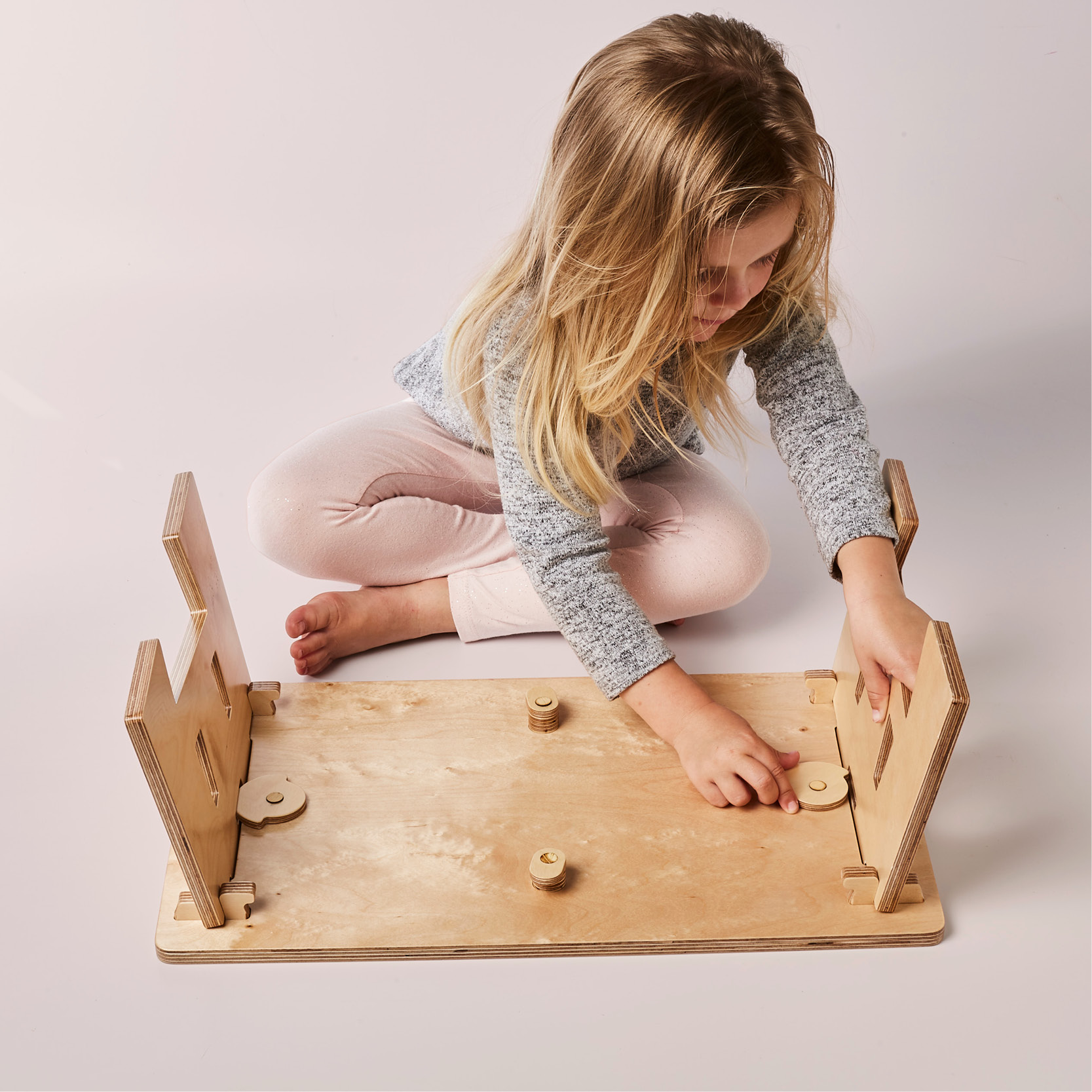child assembling the mydinky step sitting down
